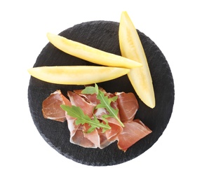 Photo of Slate plate with melon slices and prosciutto on white background, top view