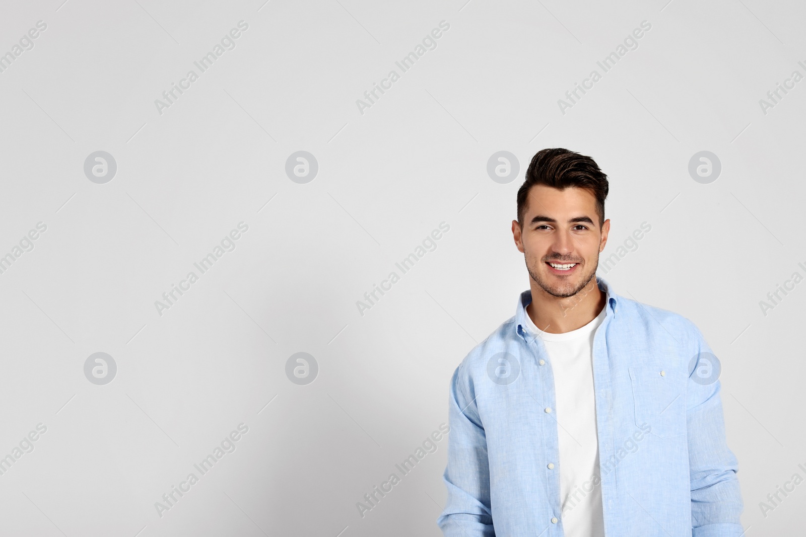 Photo of Portrait of handsome young man and space for text on white background