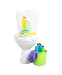 Toilet bowl and different cleaning supplies on white background