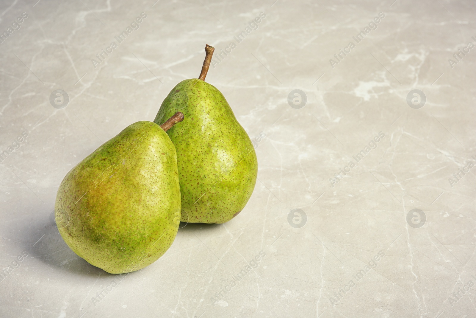 Photo of Ripe pears on grey background. Space for text