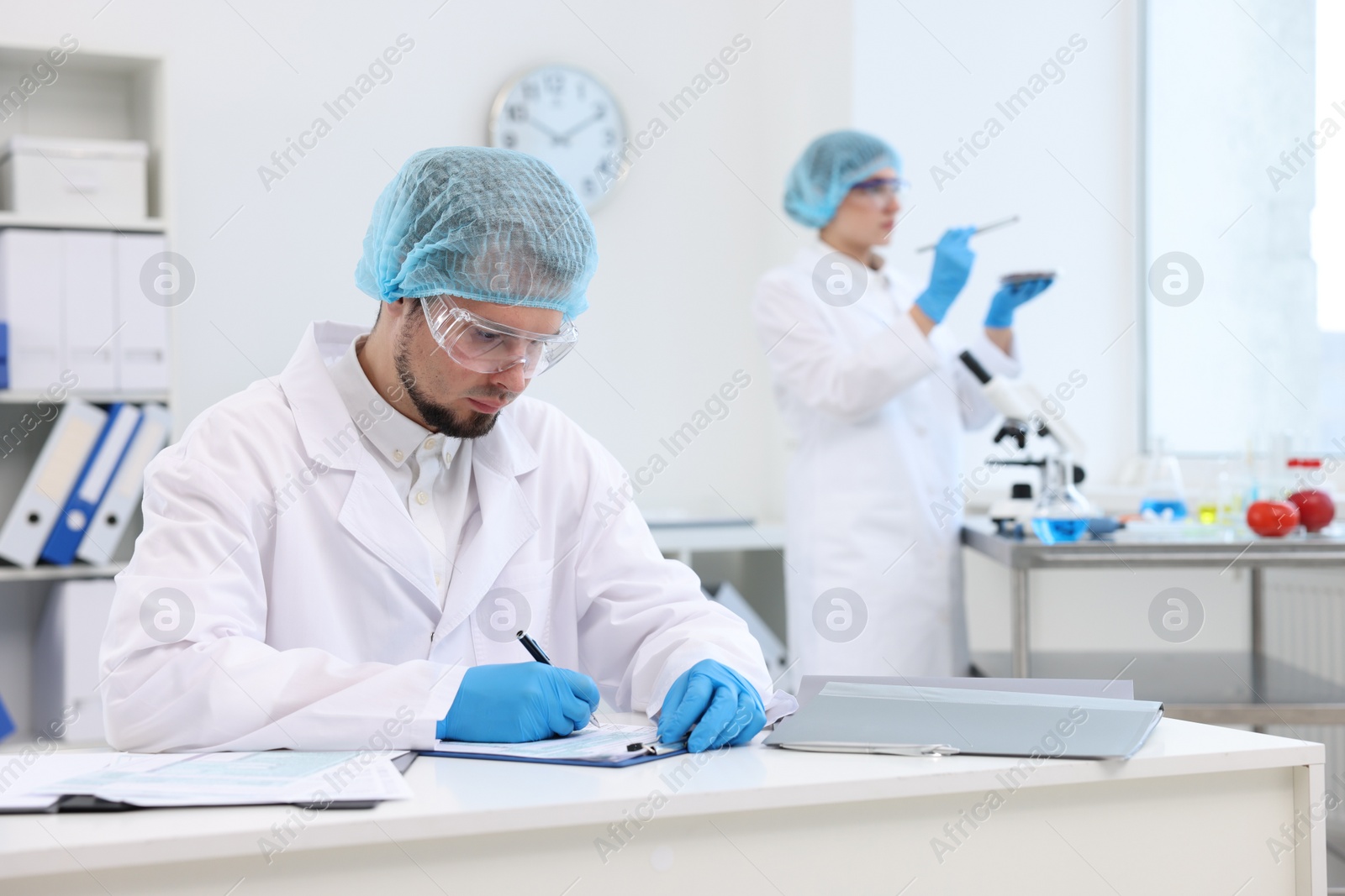 Photo of Quality control. Food inspectors checking safety of products in laboratory