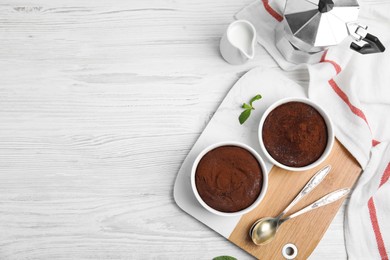Delicious chocolate fondant on white wooden table, flat lay. Space for text