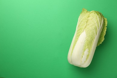 Fresh ripe Chinese cabbage on green background, top view. Space for text