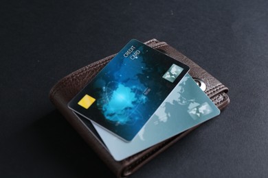Photo of Leather wallet with credit cards on grey table, closeup