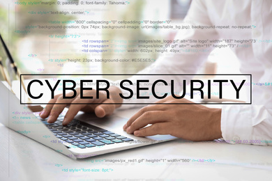 Image of Cyber security concept. Man working with laptop at table indoors, closeup