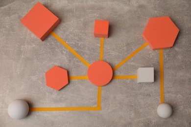 Photo of Business process organization and optimization. Scheme with geometric figures on grey table, top view