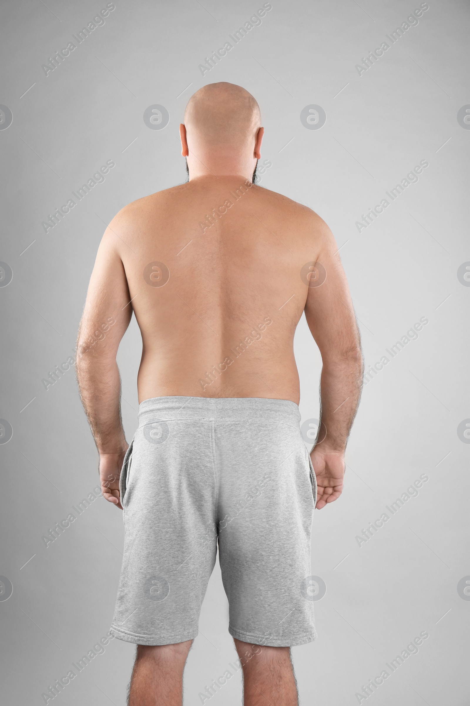 Photo of Fat man on grey background. Weight loss