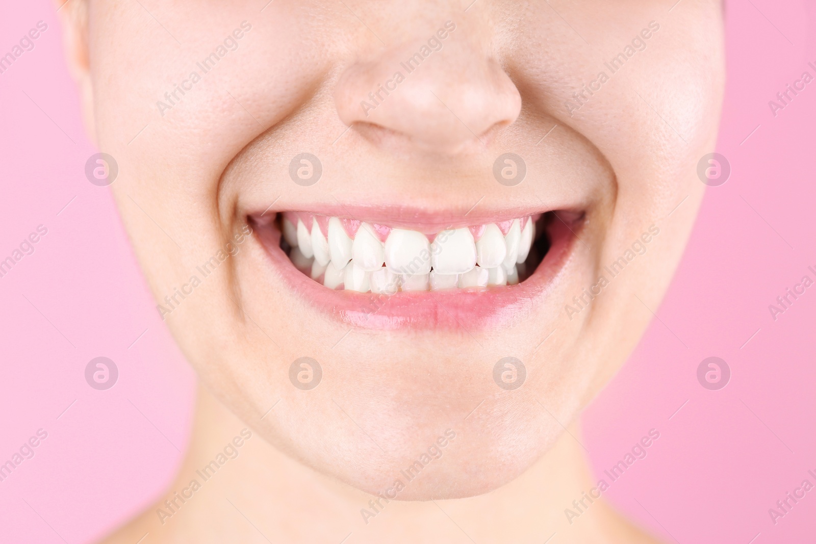 Photo of Young woman with beautiful smile on color background, closeup