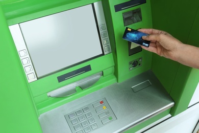 Mature woman using cash machine for money withdrawal, closeup