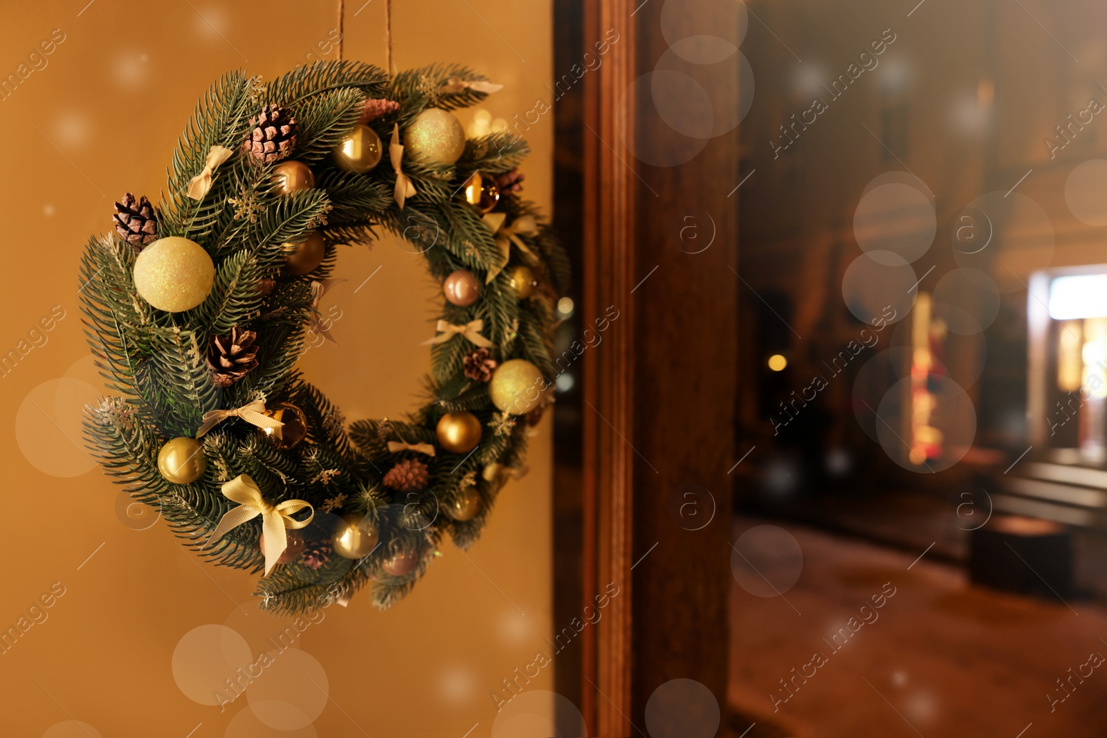 Photo of Beautiful Christmas wreath with bows, balls and cones outdoors. Space for text