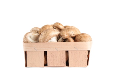 Fresh wild mushrooms in wood veneer basket on white background. Edible fungi