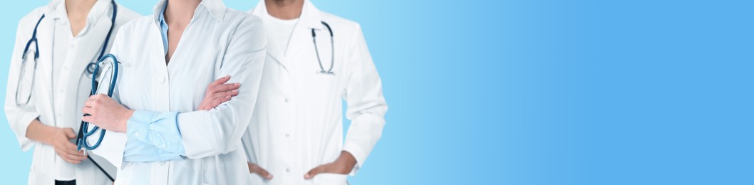 Doctors and nurse on light blue background, closeup. Banner design with space for text