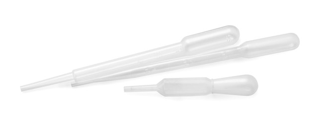 Photo of Three clean transfer pipettes isolated on white, top view