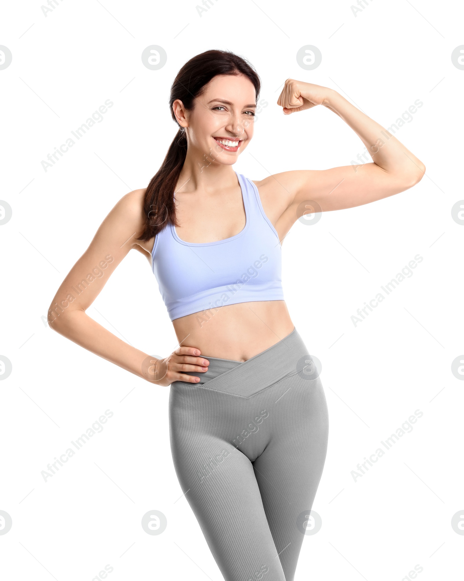 Photo of Happy young woman with slim body showing muscles on white background