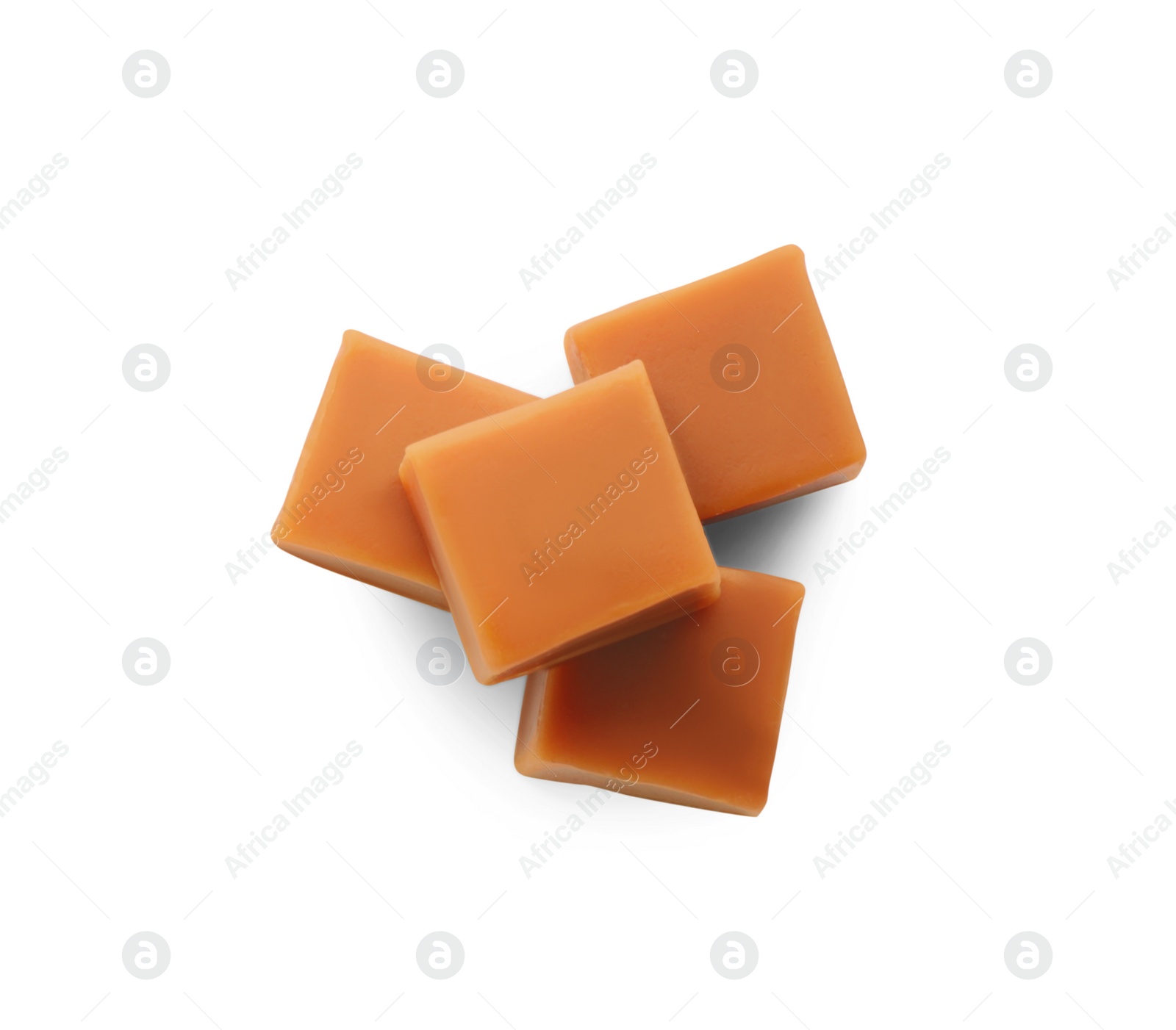 Photo of Heap of caramel candies on white background, top view