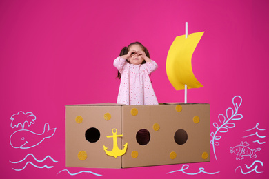 Image of Little child playing in cardboard ship on pink background with illustrations