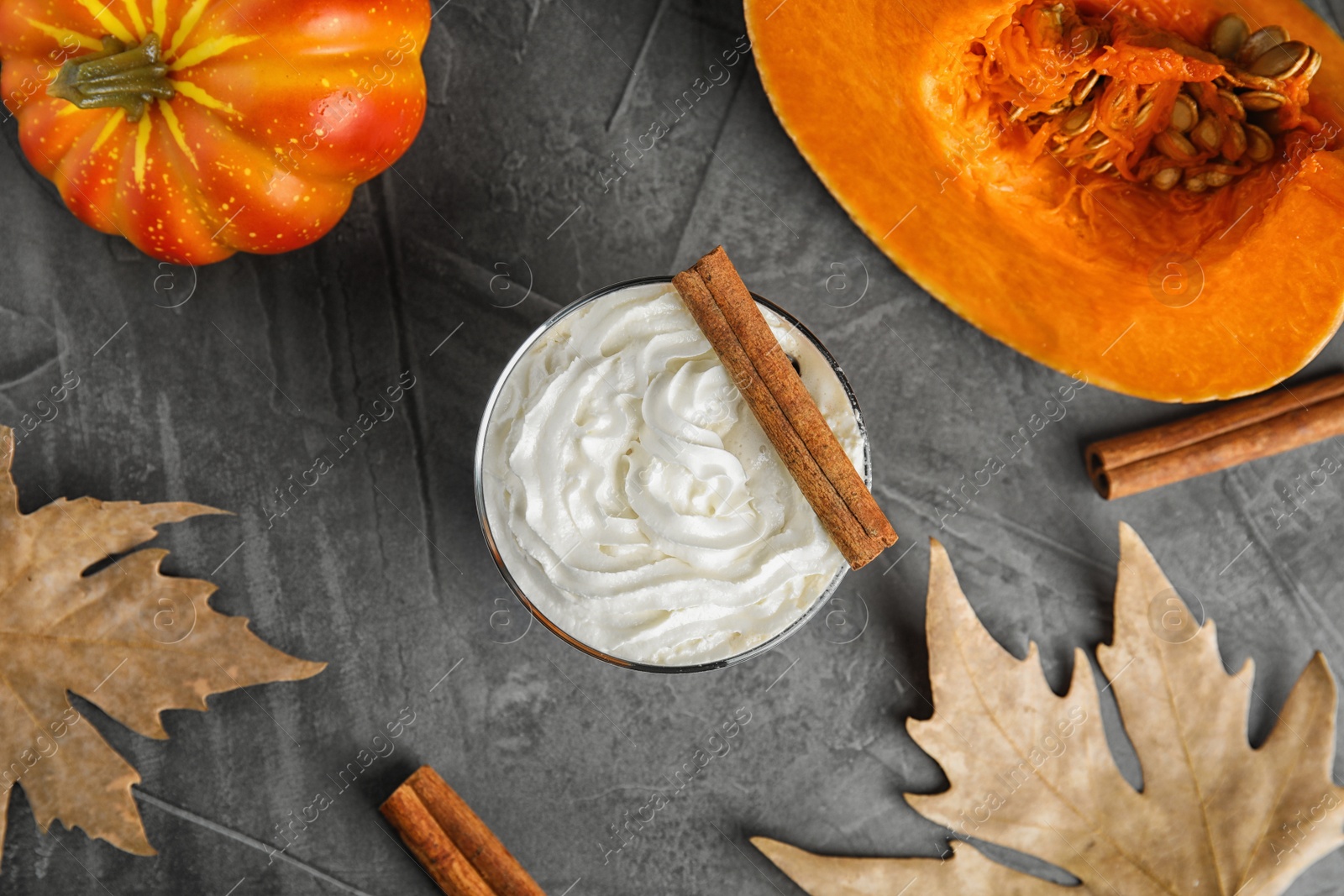 Photo of Flat lay composition with pumpkin spice latte on gray background