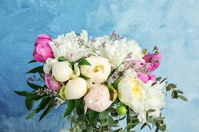 Bouquet of beautiful flowers on color background