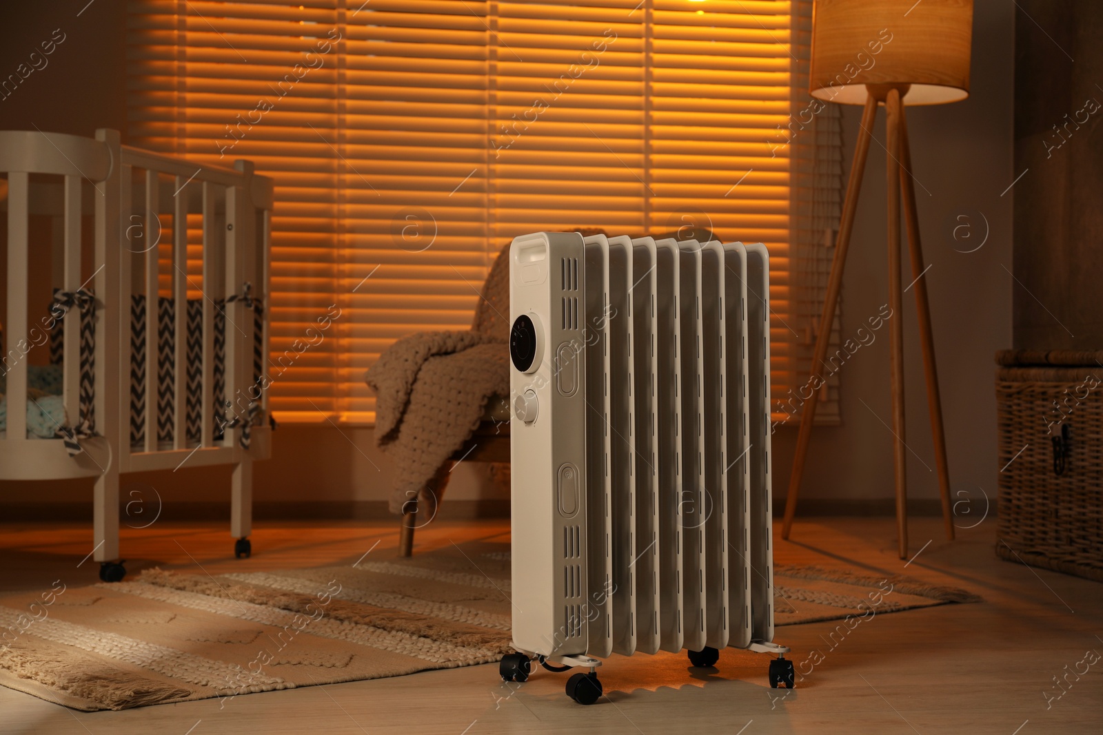 Photo of Modern portable electric heater in child room