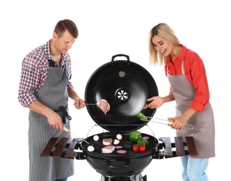 Happy couple cooking on barbecue grill, white background