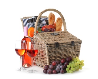 Wicker picnic basket with different products on white background