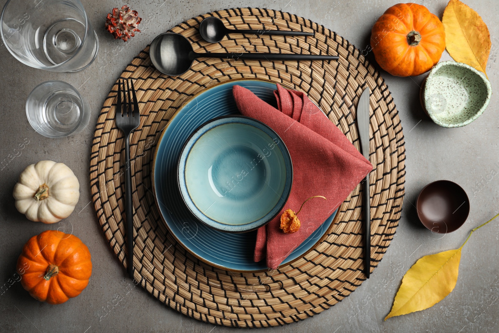 Photo of Seasonal table setting with pumpkins and other autumn decor on grey background, flat lay