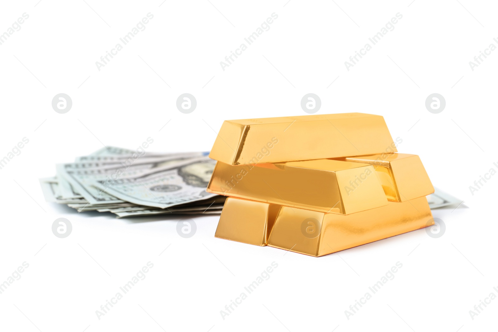 Photo of Shining gold bars and dollar banknotes isolated on white