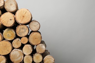 Photo of Cut firewood on grey background. Space for text