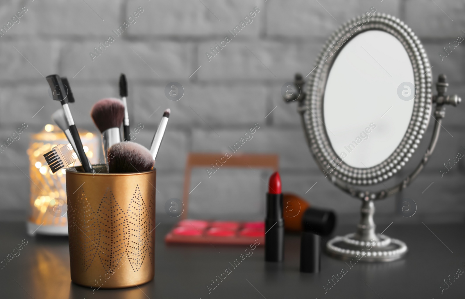 Photo of Holder with makeup brushes on table