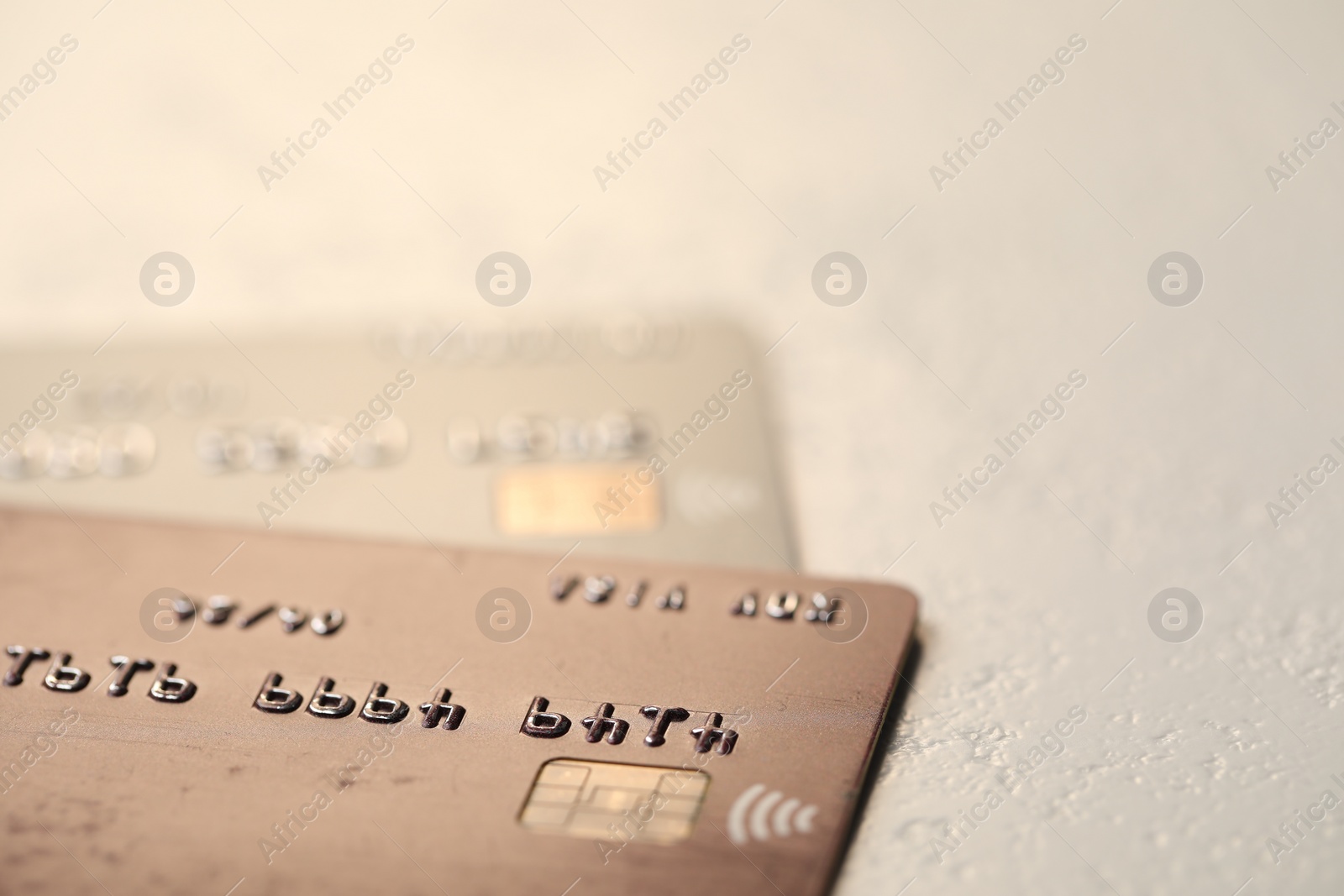 Photo of Two credit cards on gray background, closeup. Space for text