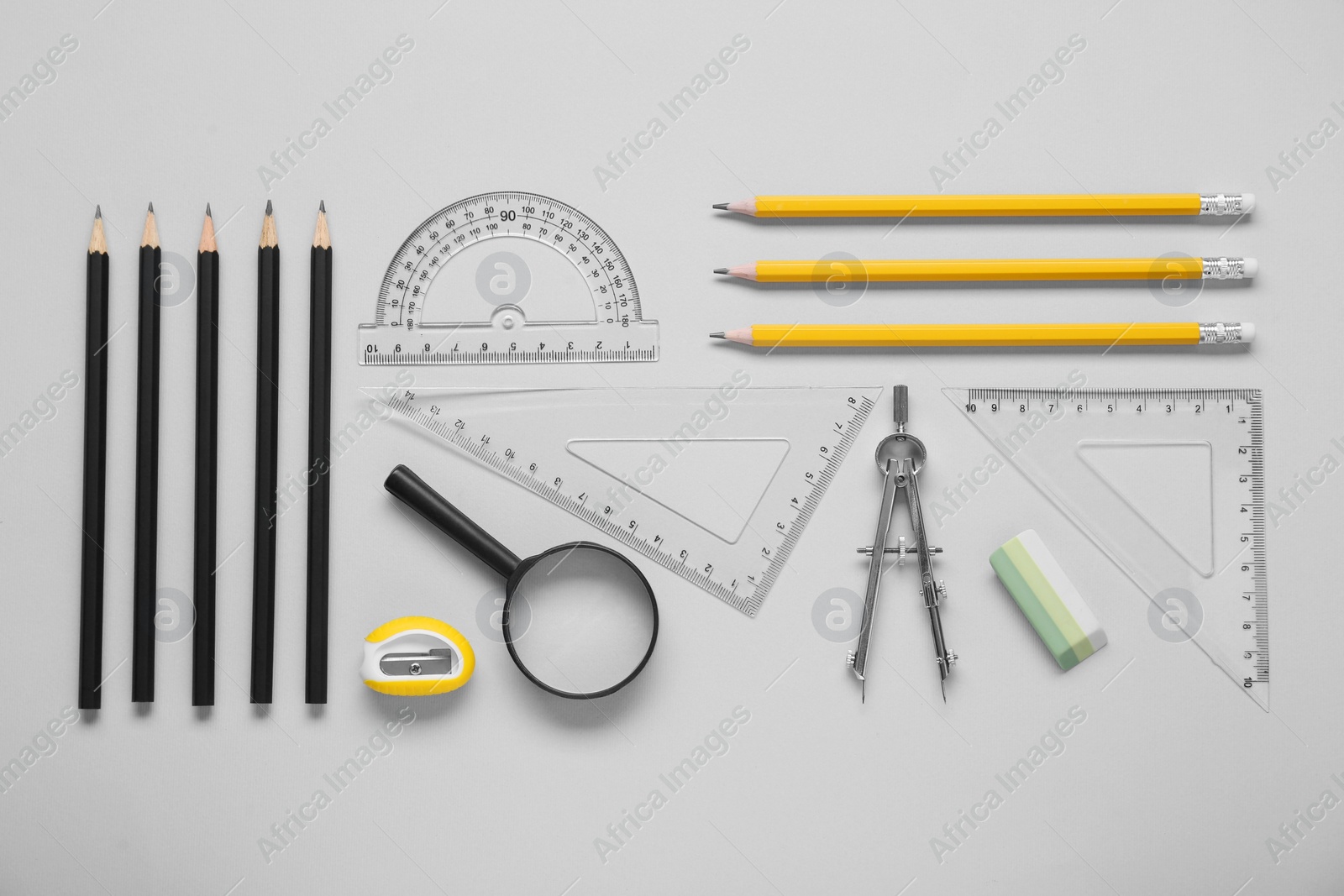 Photo of Flat lay composition with different rulers and compass on light grey background