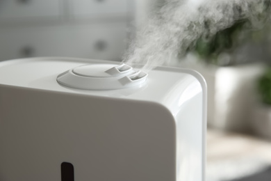 Photo of Modern air humidifier at home, closeup view