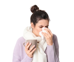 Photo of Young woman with cup of hot tea suffering from cold on white background