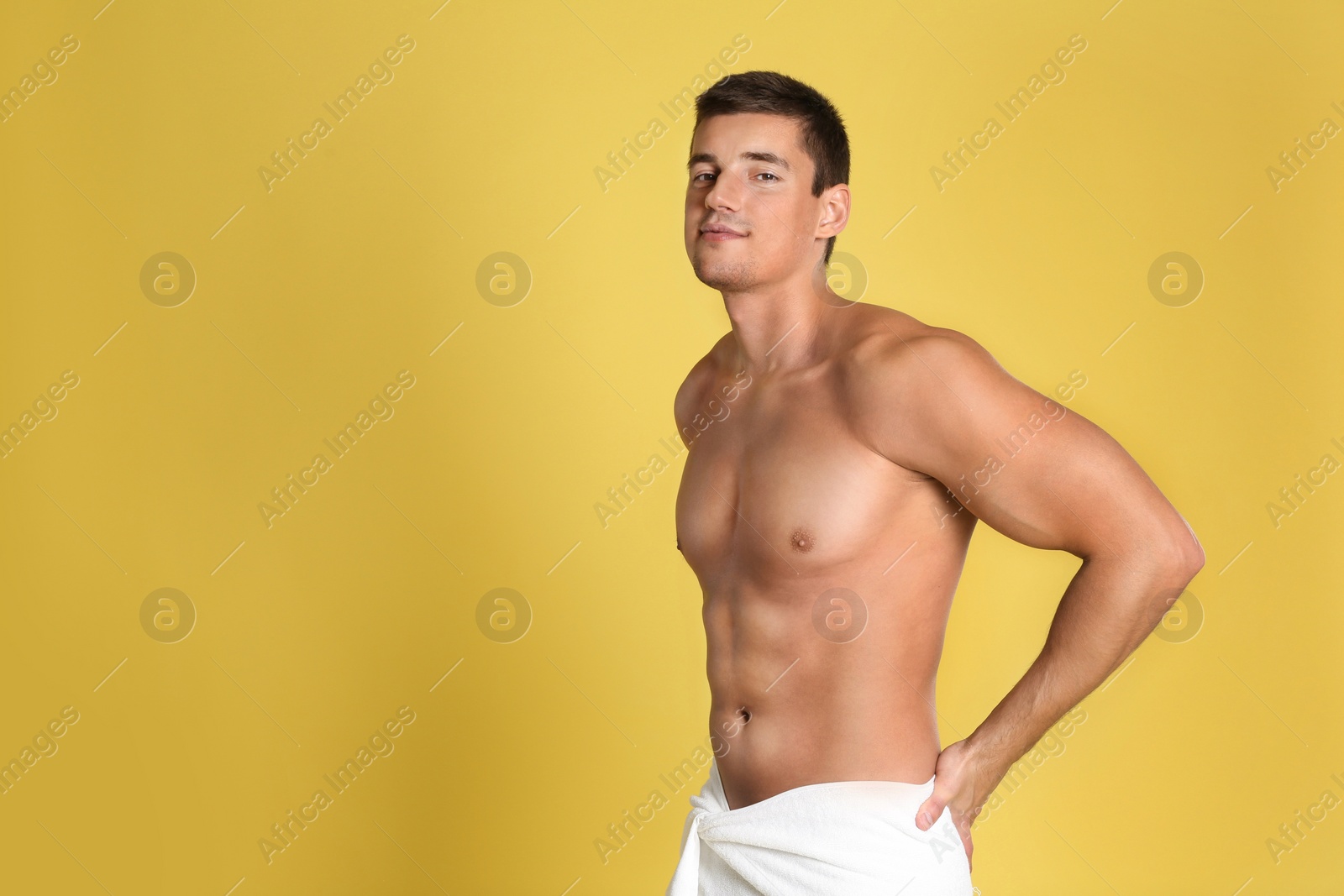 Photo of Man with sexy body on yellow background. Space for text