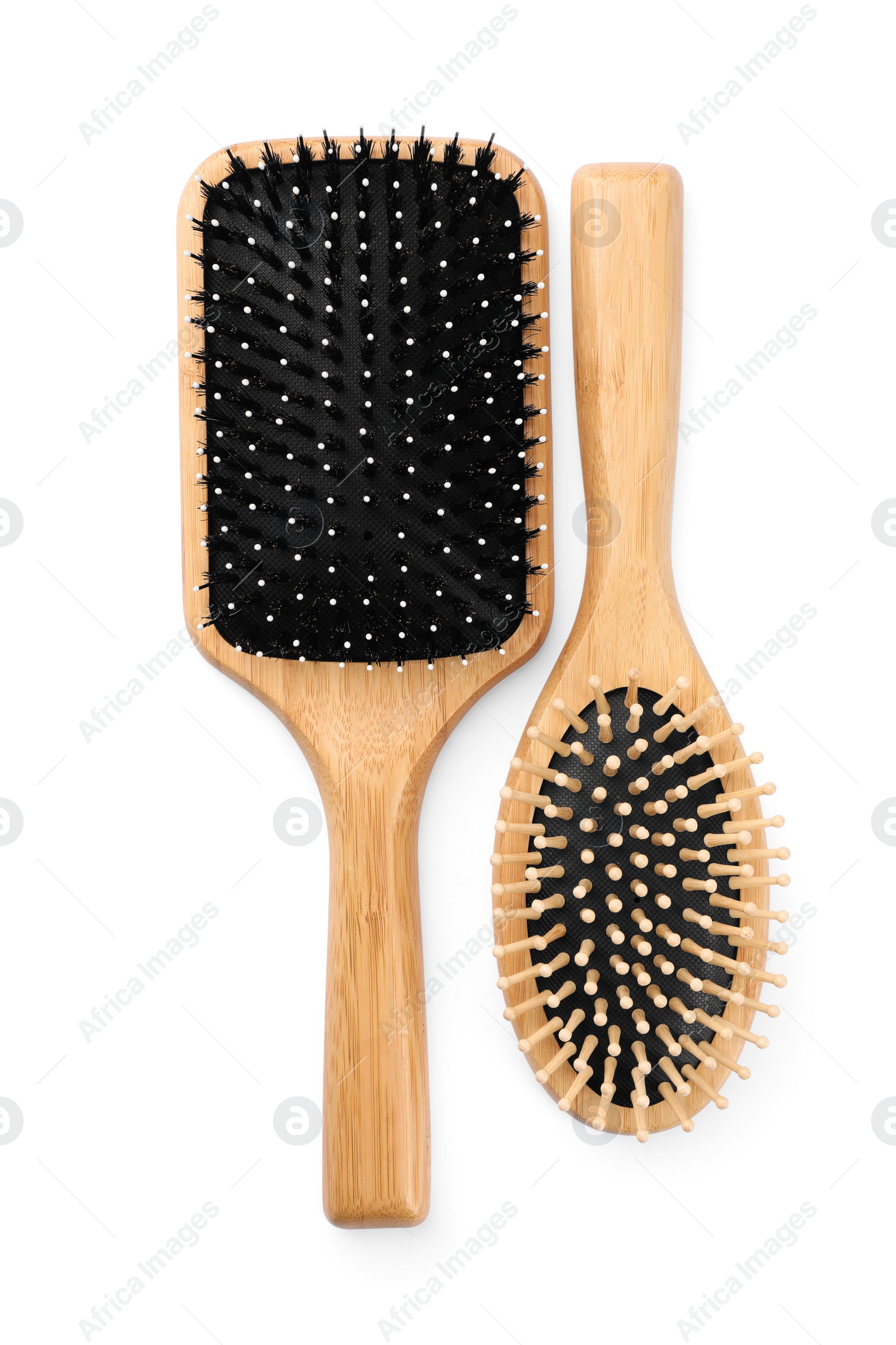 Photo of New wooden hair brushes isolated on white, top view