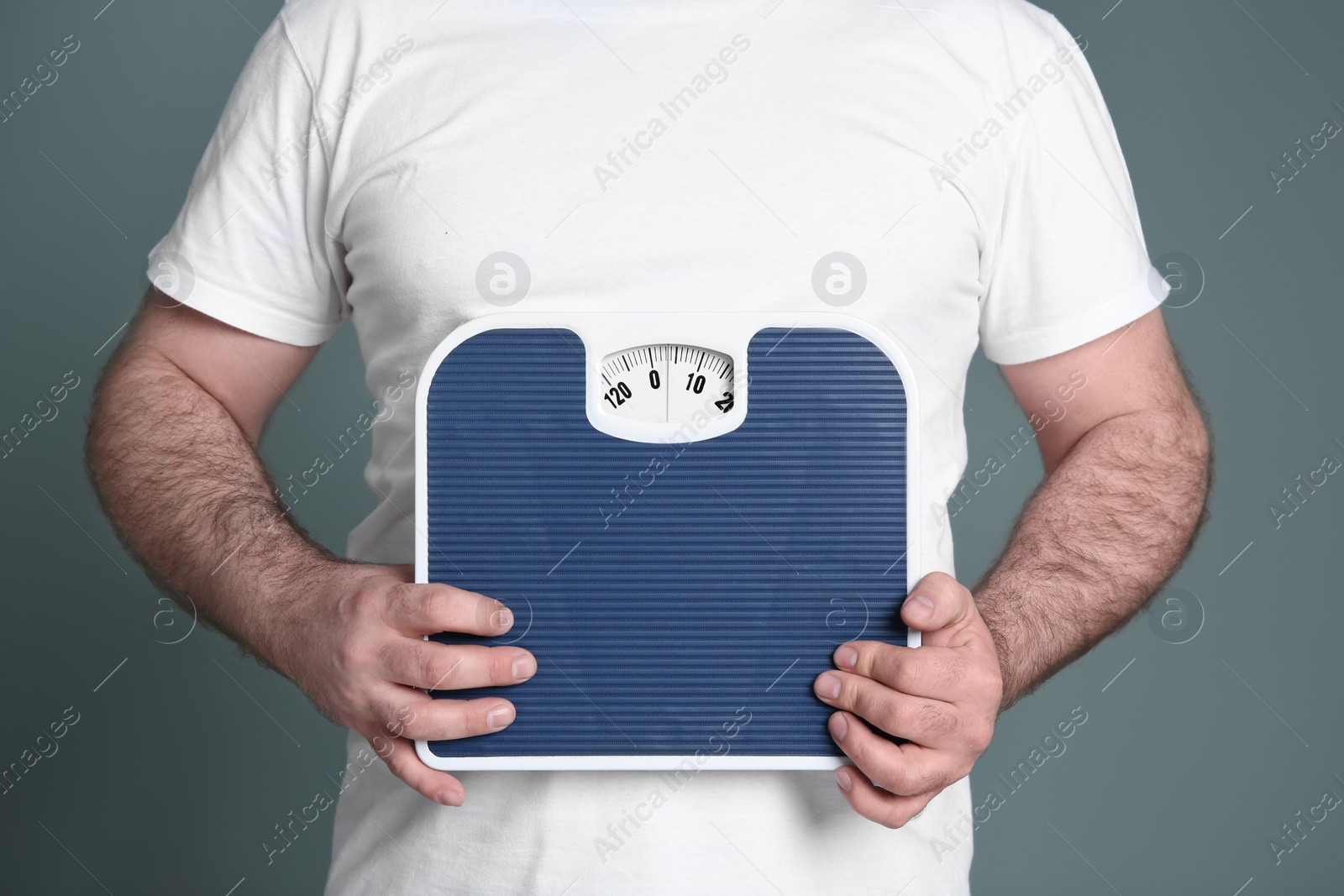 Photo of Overweight man with scale on color background