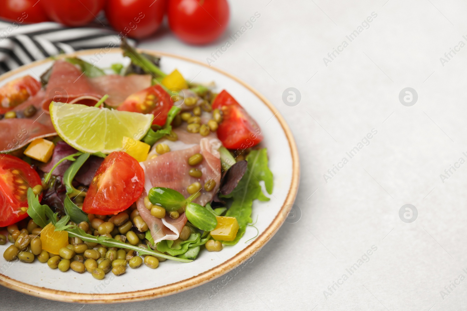 Photo of Plate of salad with mung beans on white table, space for text