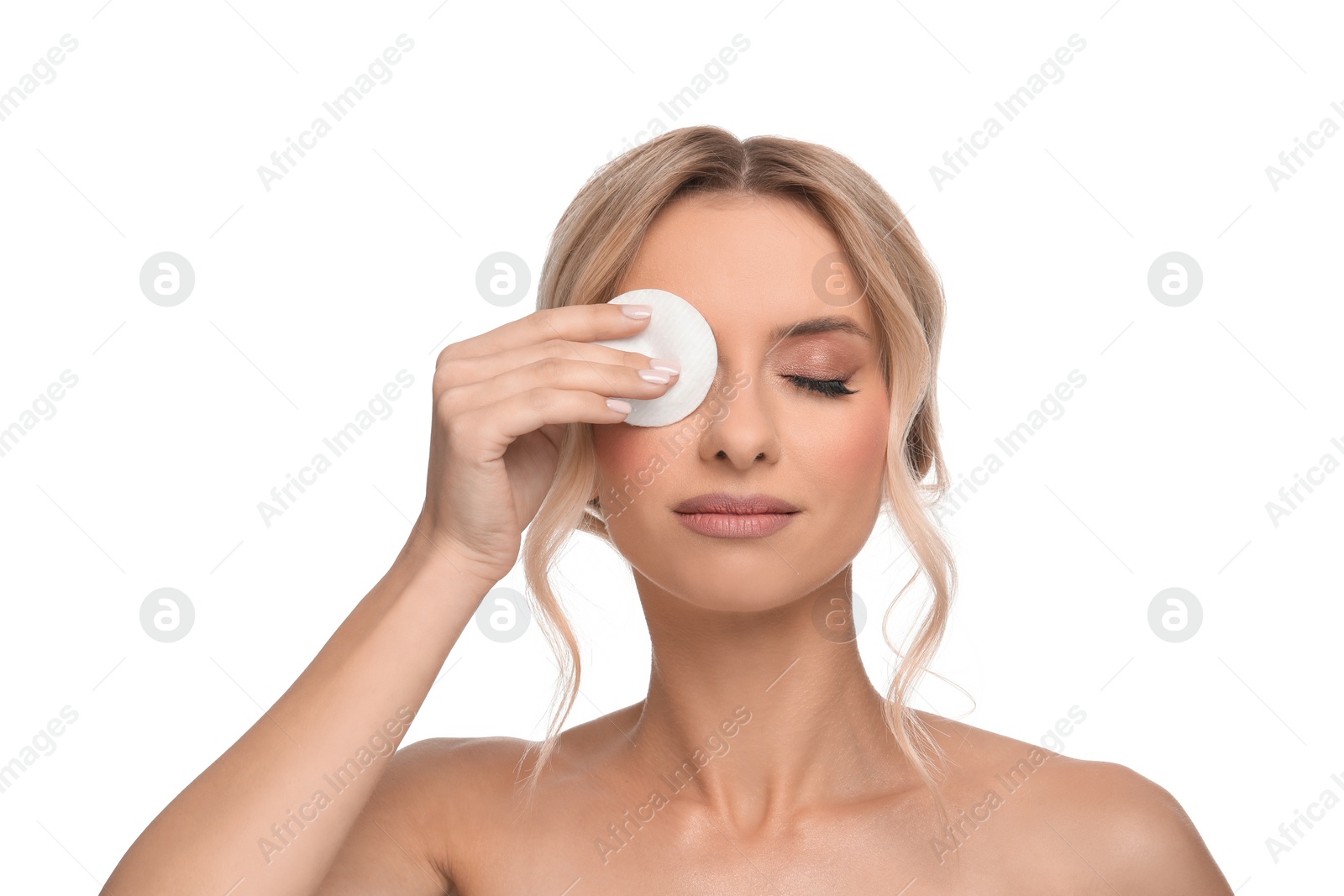 Photo of Beautiful woman removing makeup with cotton pad on white background