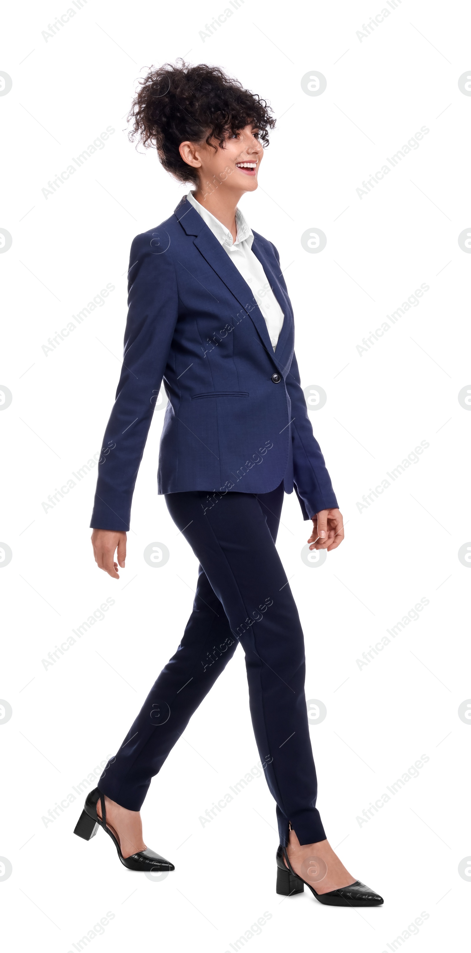 Photo of Beautiful businesswoman in suit walking on white background