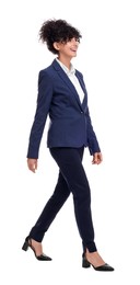 Photo of Beautiful businesswoman in suit walking on white background