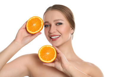 Photo of Young woman with cut orange on white background. Vitamin rich food