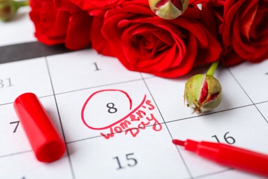 Photo of Roses and red marker on calendar near date 8th of March, closeup. International Women's Day