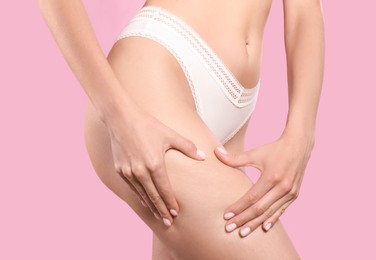 Photo of Closeup view of slim woman in underwear on pink background. Cellulite problem concept
