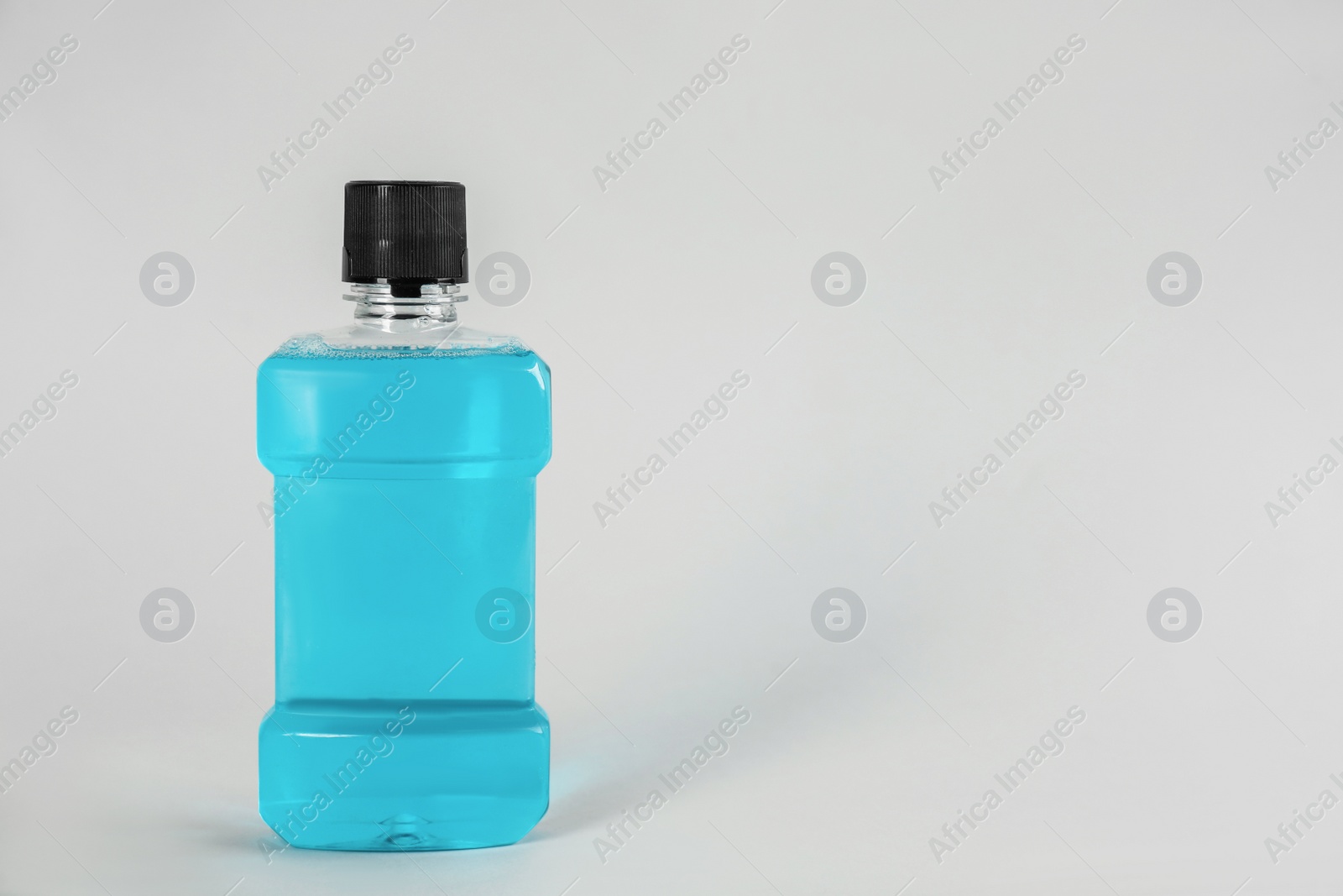 Photo of Mouthwash on light grey background, space for text