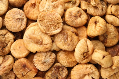 Photo of Many tasty dried figs as background, top view