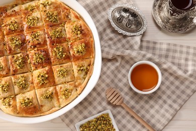 Delicious sweet baklava served on white table, flat lay