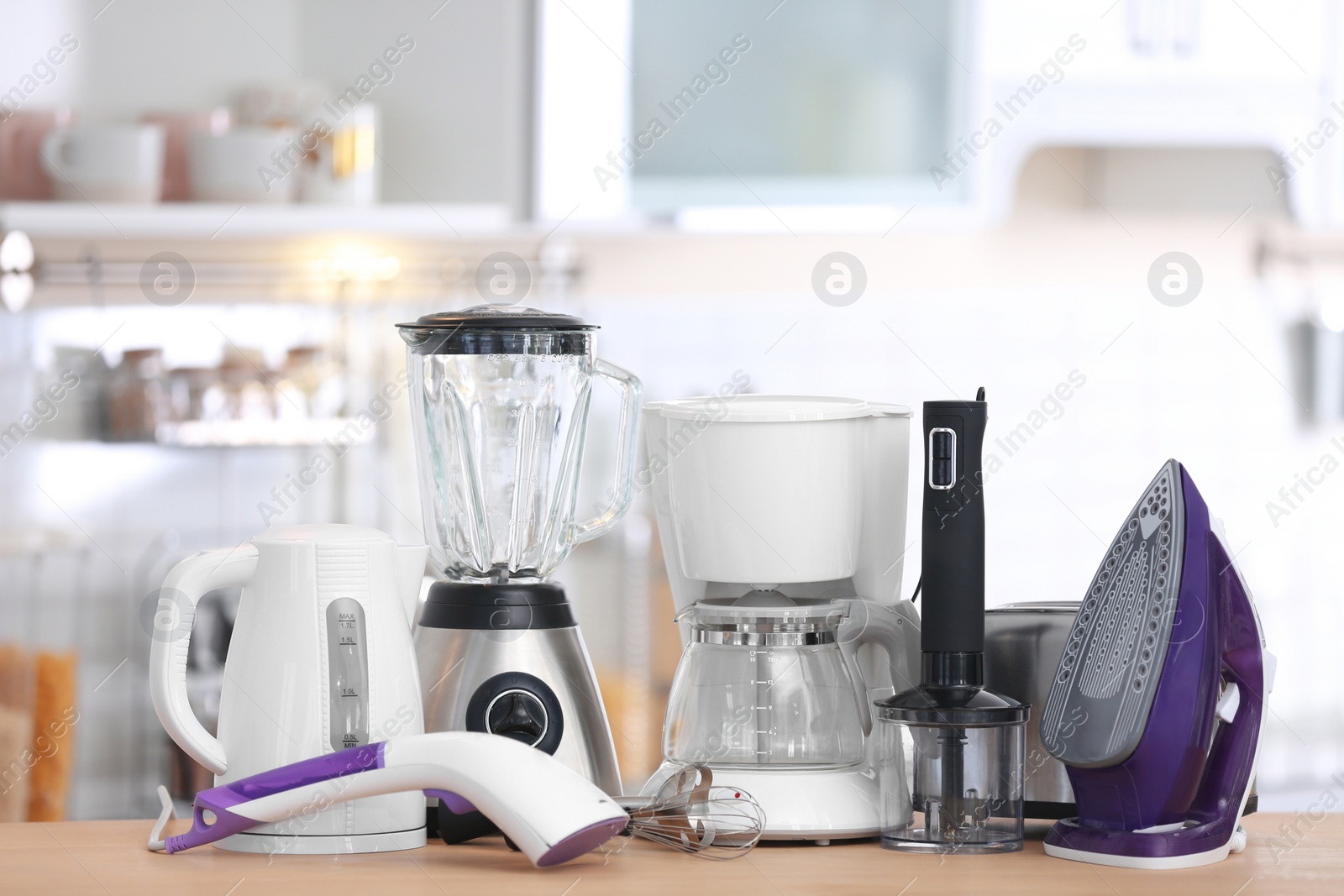 Photo of Household and kitchen appliances on table indoors. Interior element