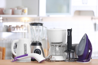 Photo of Household and kitchen appliances on table indoors. Interior element