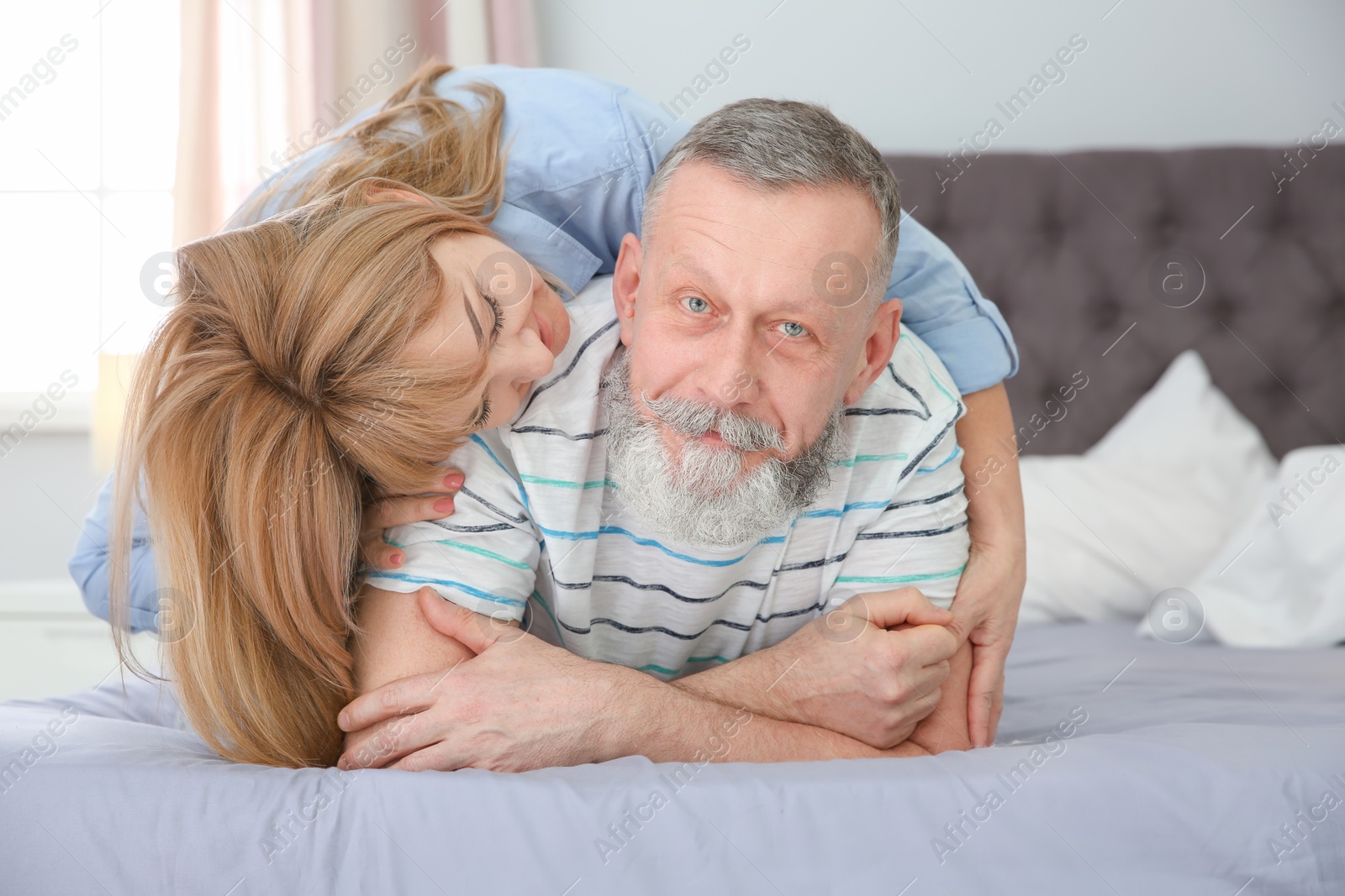 Photo of Mature couple together on bed at home