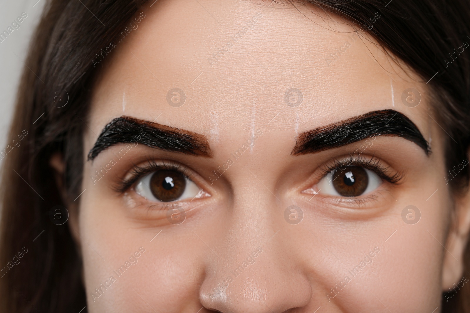 Photo of Woman during eyebrow tinting procedure, closeup view